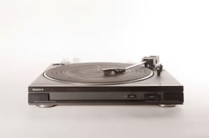 Vinyl record player on white background