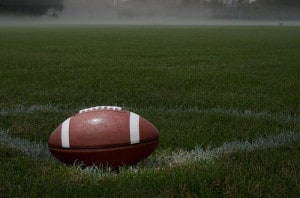 football sitting on a field in the mist stock photo of a football sitting on a green grass field