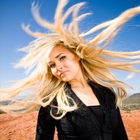 Portrait photo of a woman with her hair twirling around--fun!