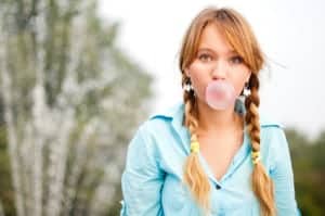 A young woman gets a portrait photo tip when using bubblegum as a prop.