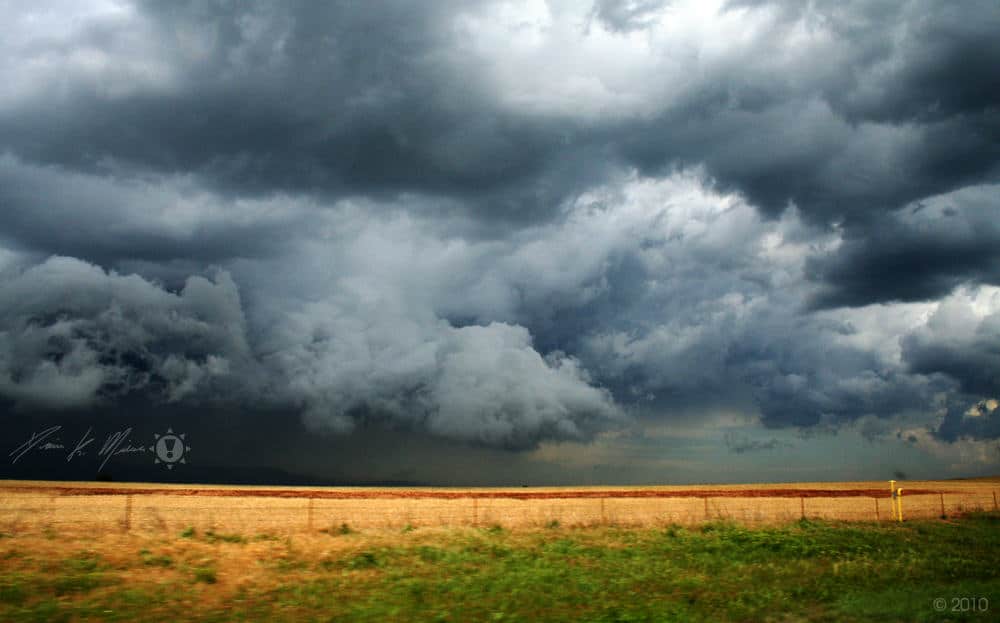 Photo of a spring thunder storm moving across a farm.