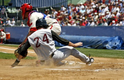 baseball player sliding into home plate
