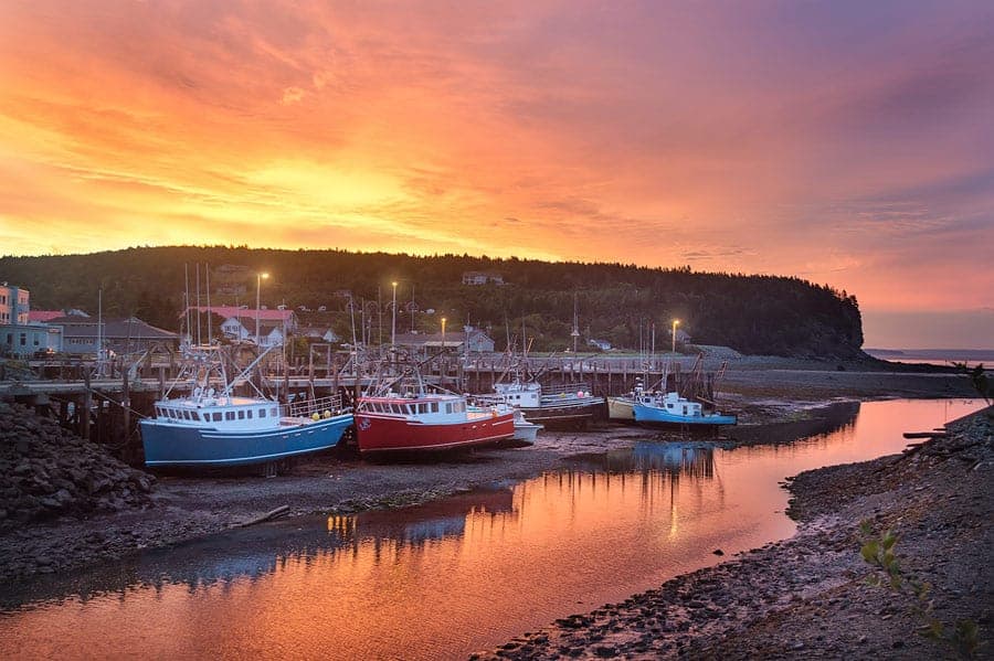 A photo of grounded fishing boats during low tide at sunrise in Alma, just outside of Fundy National Park, NB.