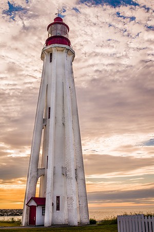 A photo of the Pointe Au Perè Lighthouse in Rimouski, QC at sunset.