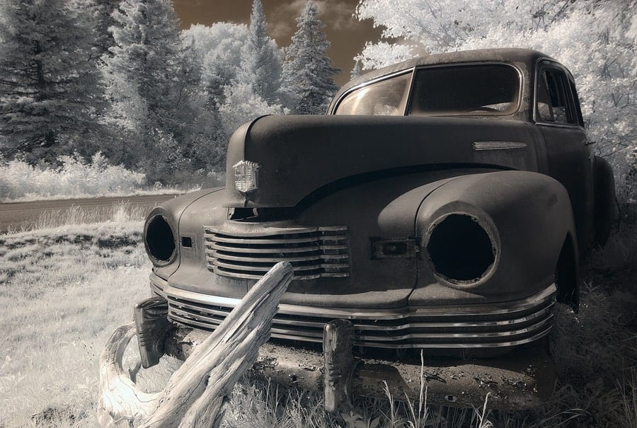 An infrared photo of a rusted truck.