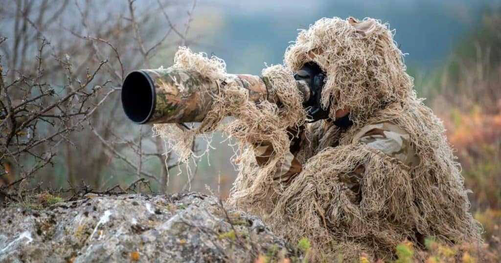 wildlife photographer in the ghillie suit working