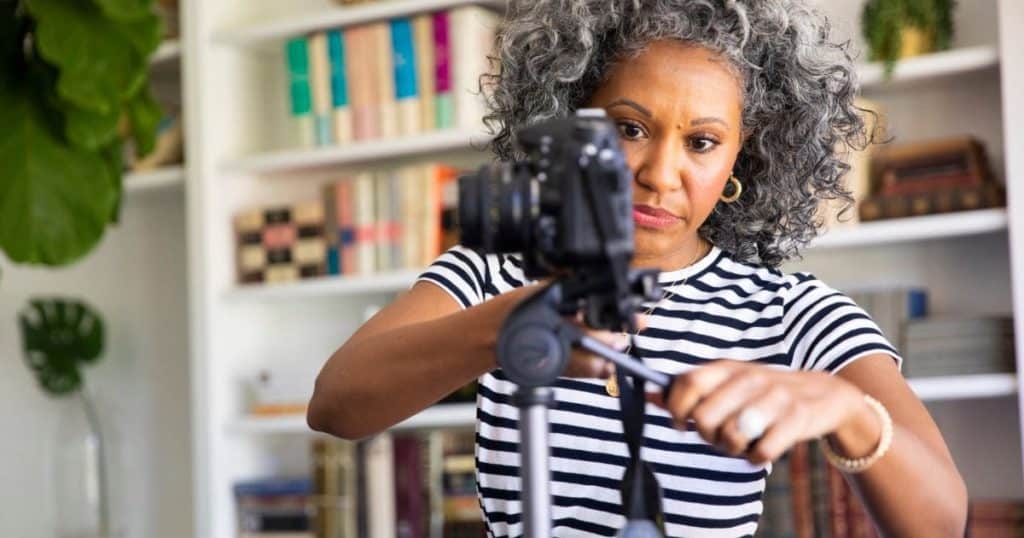black woman setting up tripod and camera