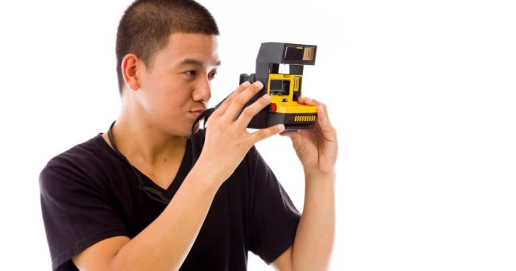 Man with Polaroid OneStep Camera