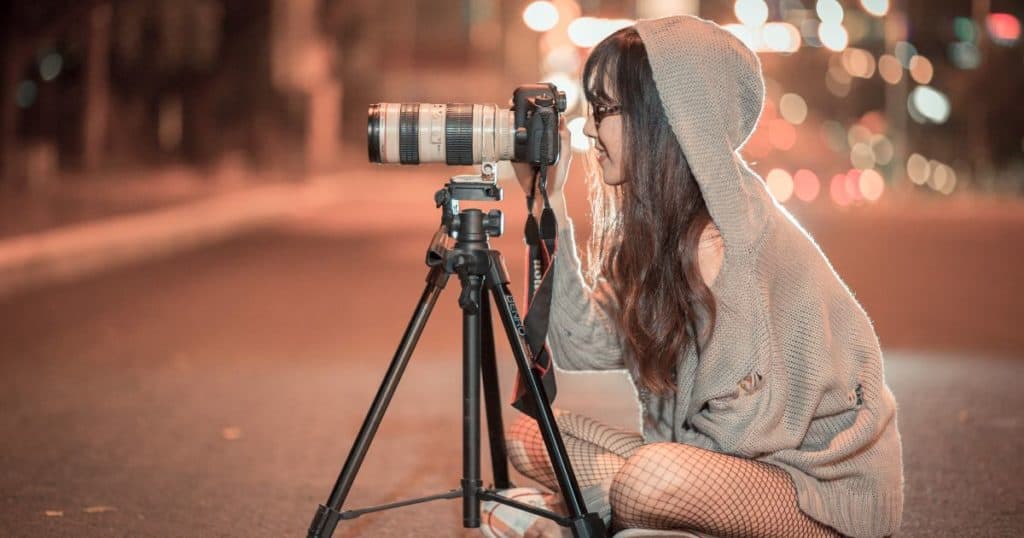 woman photographer taking pictures at night